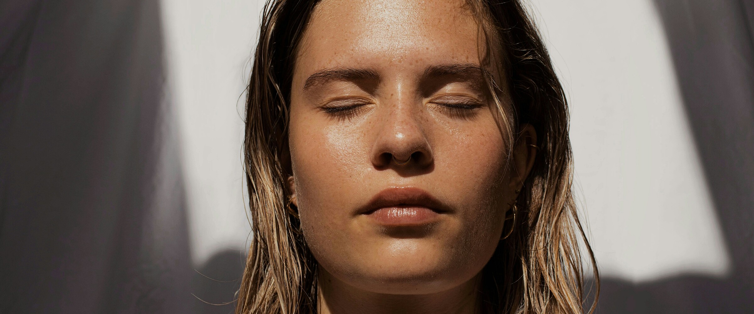woman with eyes closed in the sun