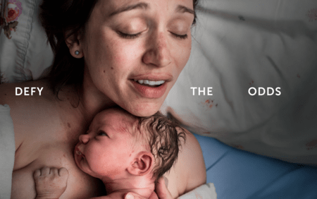 woman holding baby to chest